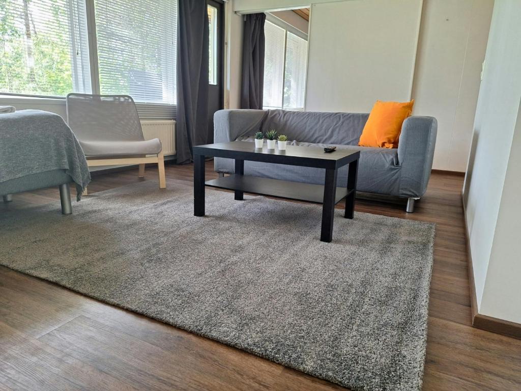 a living room with a couch and a coffee table at Spacious Apartment for 5 in Sodankylä