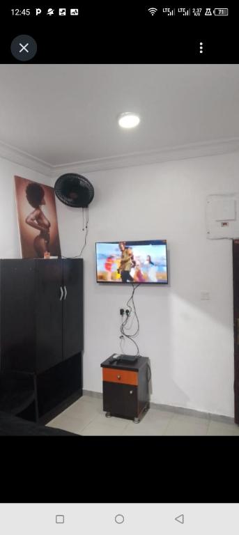 a room with a flat screen tv on a wall at Short Let Apartments in Lagos Business School Lekki Ajah in Lekki