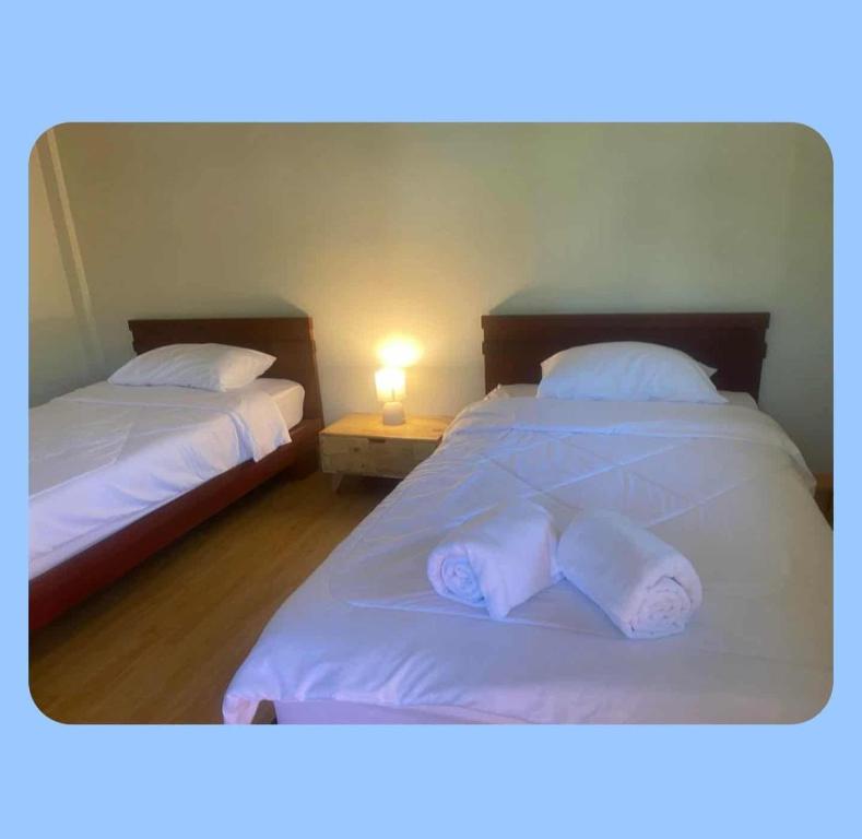 Postel nebo postele na pokoji v ubytování ບ້ານ ດາວເຈົ້າ