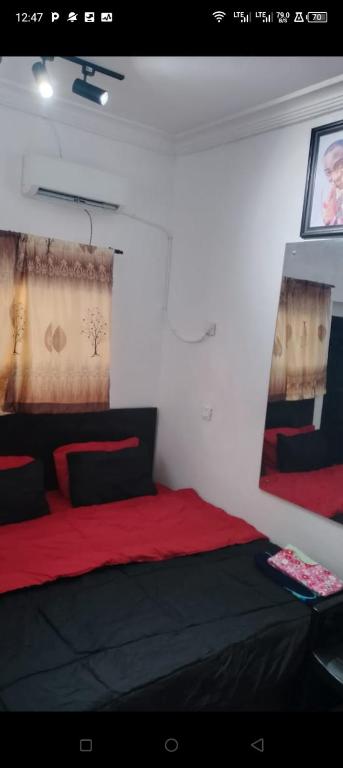 a bedroom with a red and black bed in a room at Short Let Apartments in Lagos Business School Lekki Ajah in Lekki