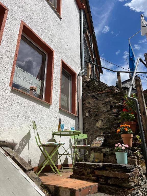 a patio with a table and chairs outside of a building at Ferienhaus Mauseloch in Kaub