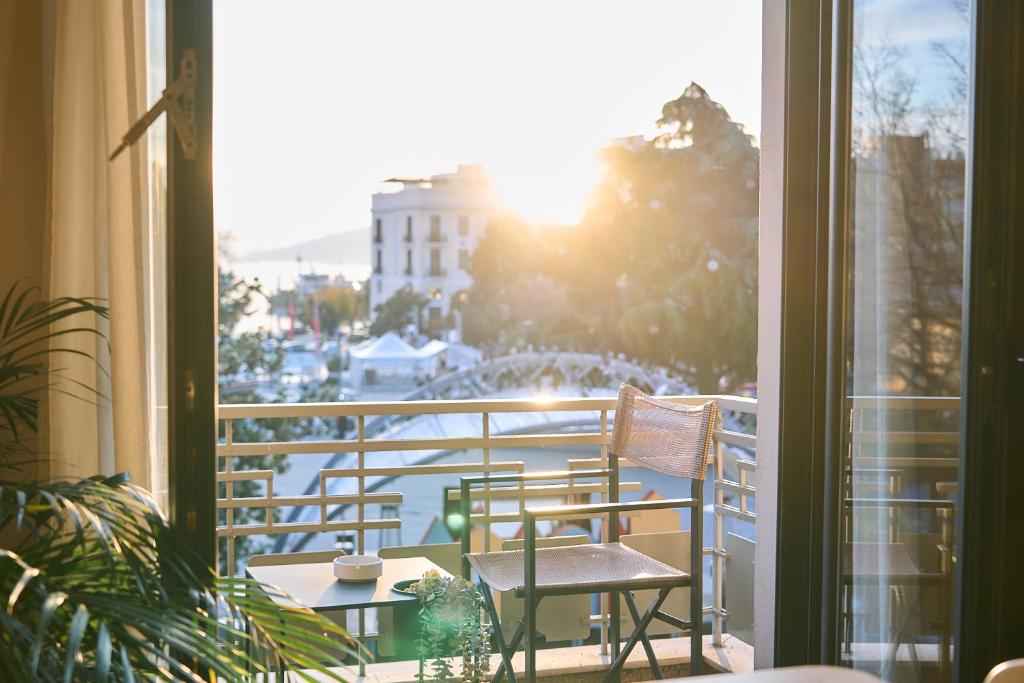 ein Balkon mit zwei Stühlen und Blick auf eine Stadt in der Unterkunft Urban Flat 2026 - At Central Square - Pet Friendly in Kavala