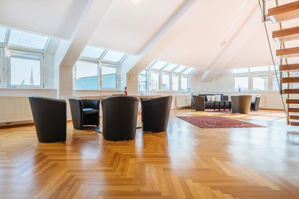 a room with chairs and tables in a building with windows at Duschel Apartments City Center in Vienna