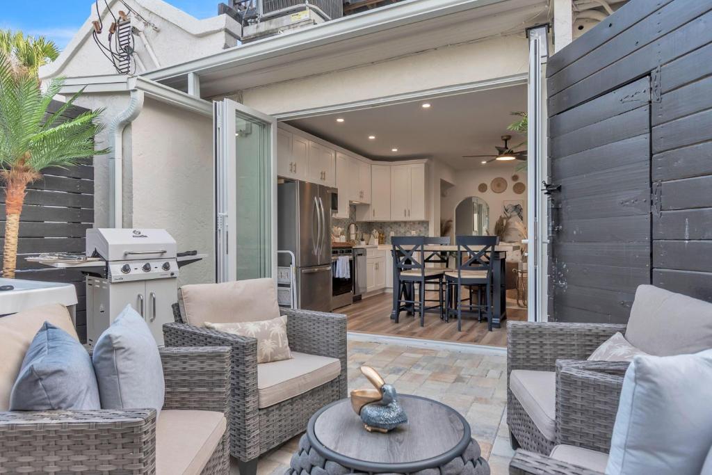 a patio with chairs and a table and a kitchen at La Barra #101.5 in St. Pete Beach