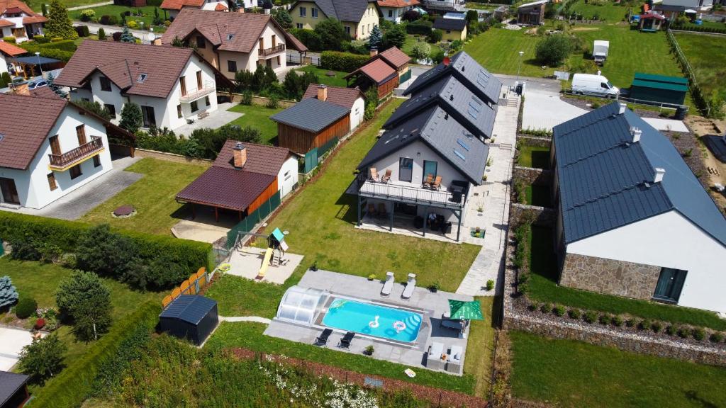 an aerial view of a house with a swimming pool at Apartmánové domy Lipno 1 in Frymburk