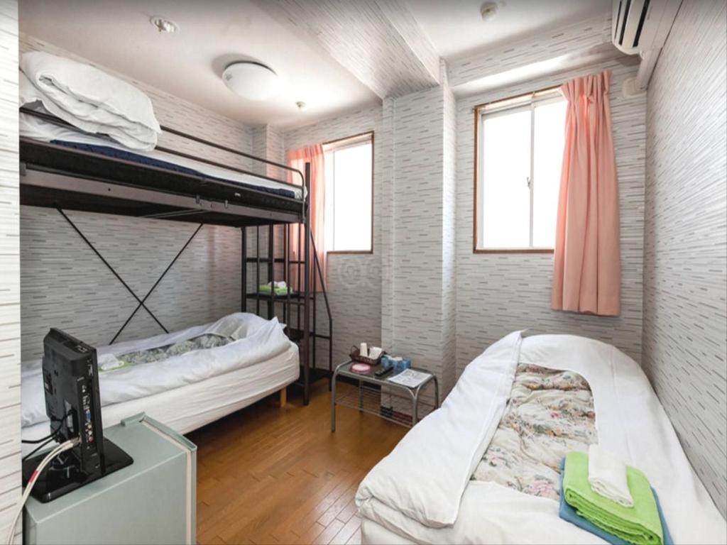 Postel nebo postele na pokoji v ubytování Hotel Raizan South
