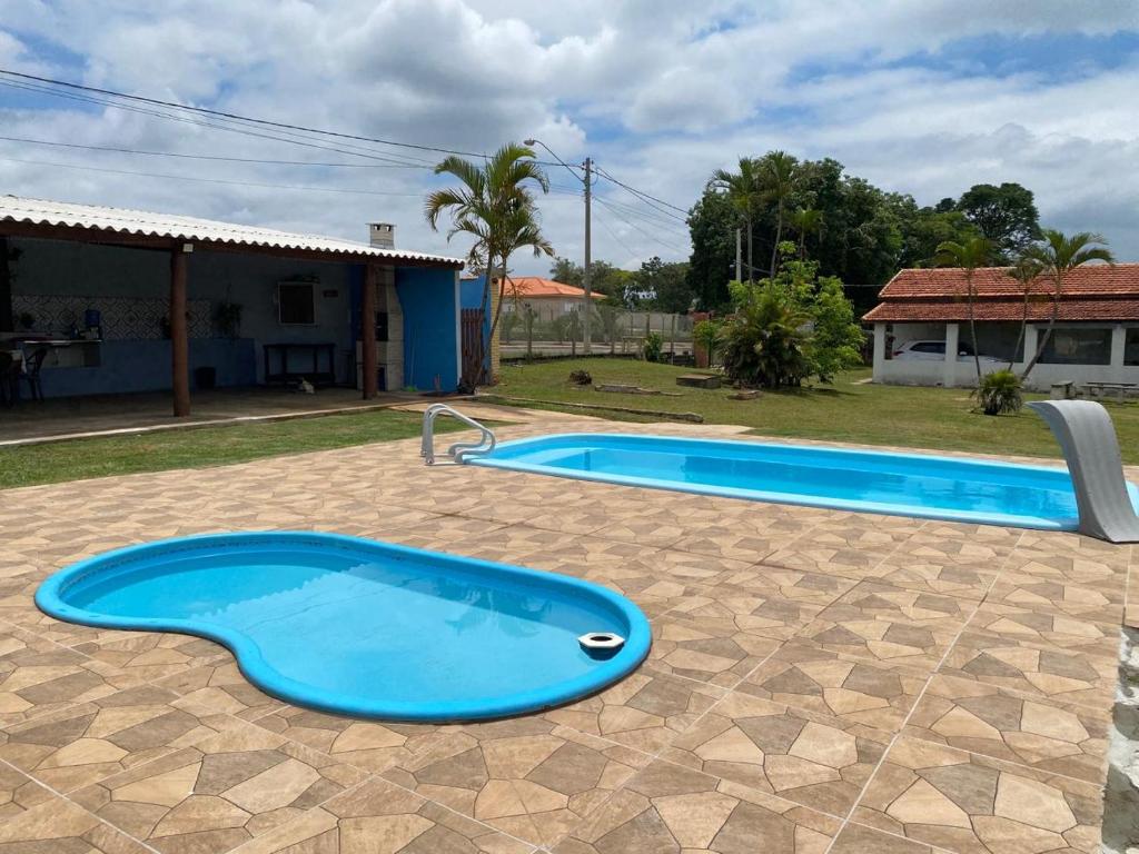 een groot blauw zwembad in een tuin bij Chácara Andorinhas São Pedro SP in São Pedro