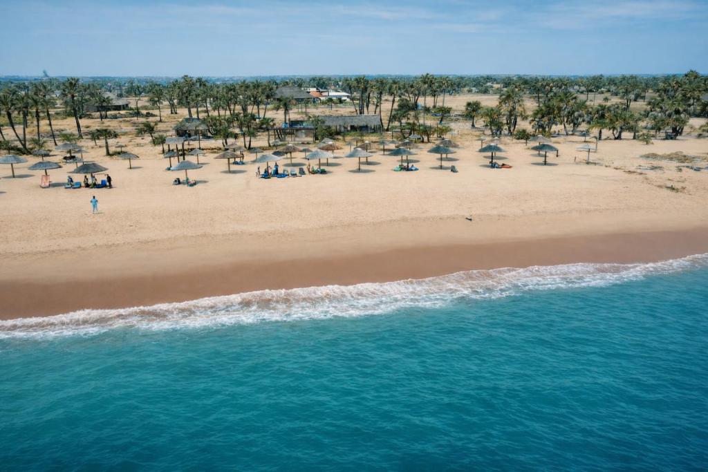 an aerial view of a beach with people and umbrellas at Netu's Village Resort in Belas