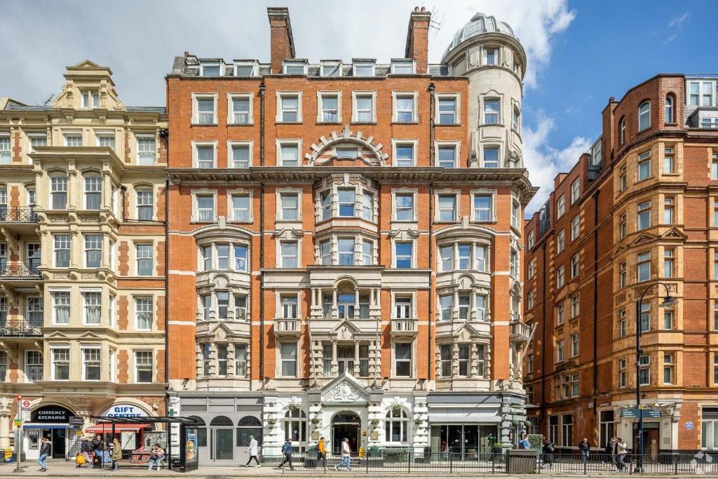 a large brick building with people walking in front of it at voco London - Bloomsbury by IHG in London