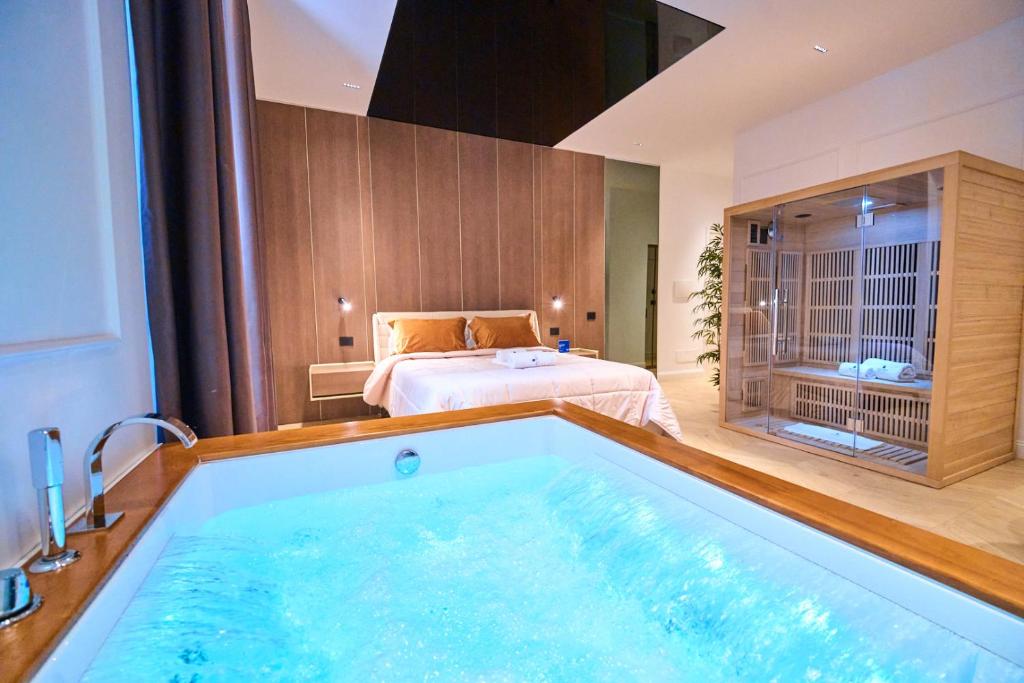 a hotel room with a large bath tub with a bed at Boutique Suites - Palazzo Crati 1800 in Cosenza