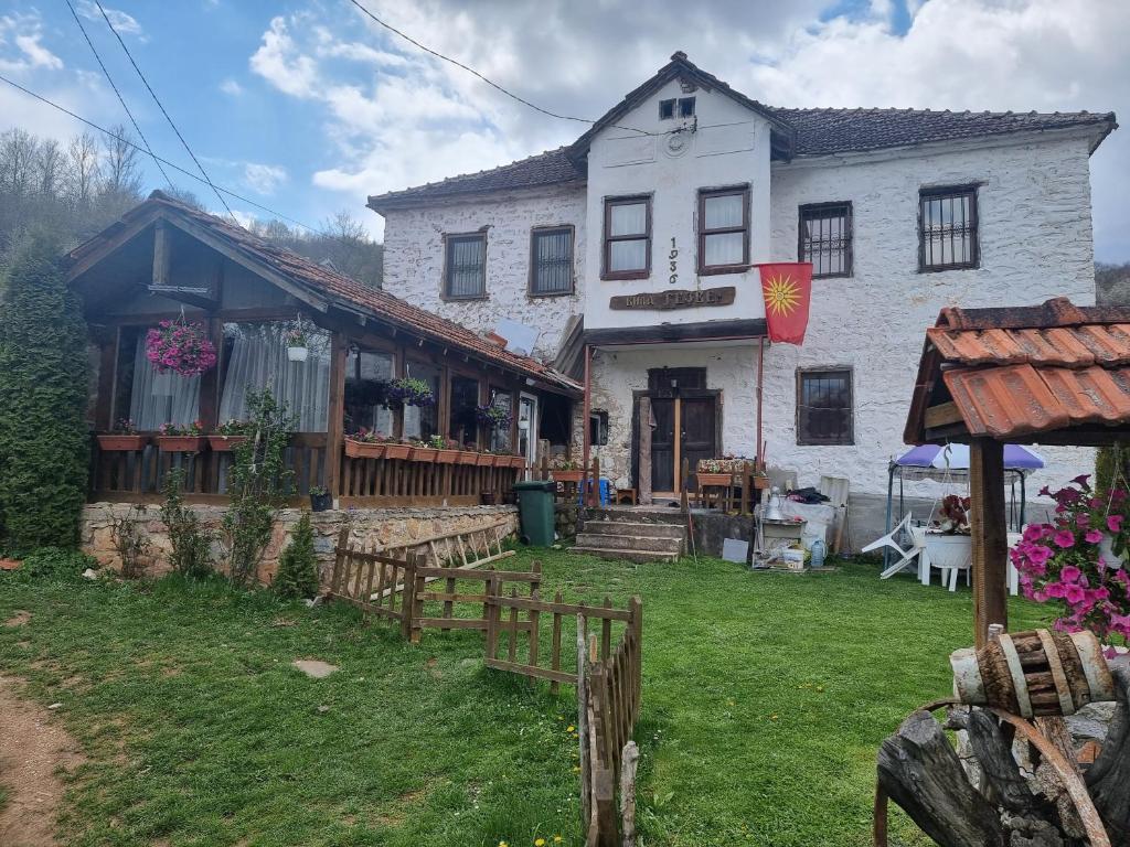 a white house with a yard in front of it at Villla Gezve in Velmevci
