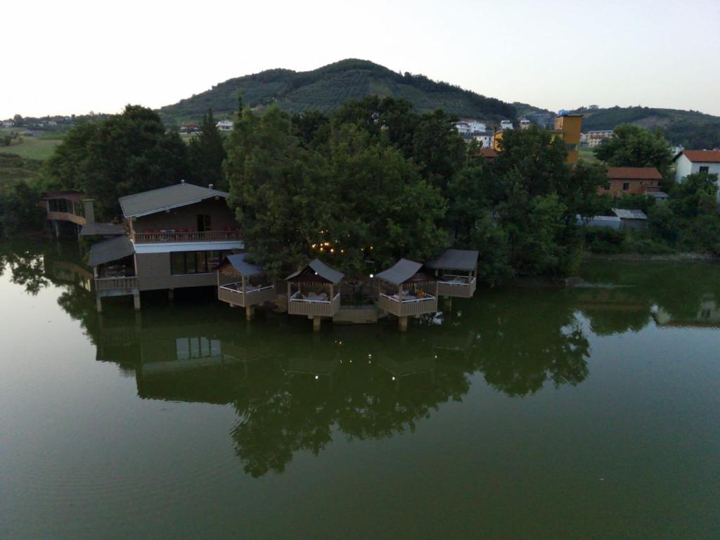 an aerial view of a house on a lake at Hotel Liqeni in Elbasan