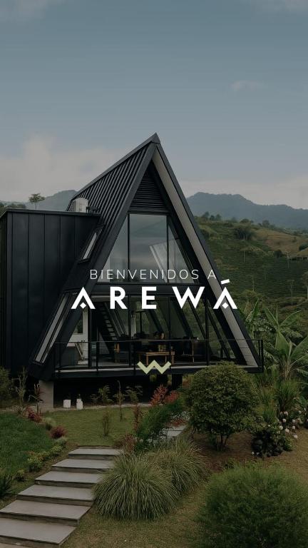 a black building with a sign on the side of it at AREWÁ Biohabitat in Buenavista