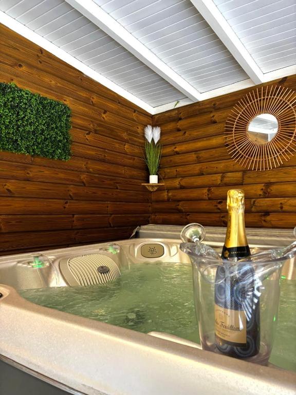 a champagne bottle sitting in a kitchen sink at La bulle D'Isma - Jacuzzi intimiste, proche plage in Le Gosier
