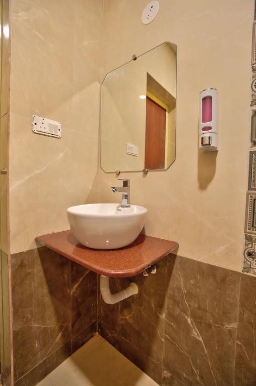 a bathroom with a sink and a mirror at Goa Radha Krishna holiday in Calangute