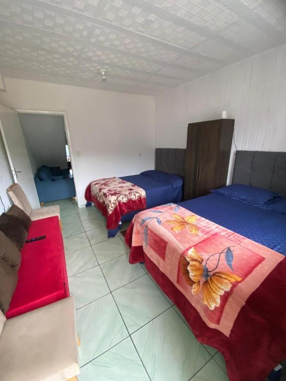 En eller flere senge i et værelse på Kitnet aconchegante