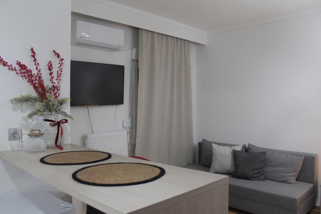 a living room with a table and a couch at La Casa in Kozani