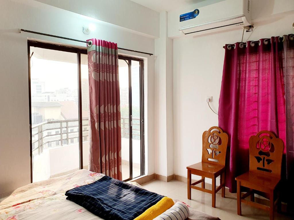 Postel nebo postele na pokoji v ubytování Evercare View Apartment