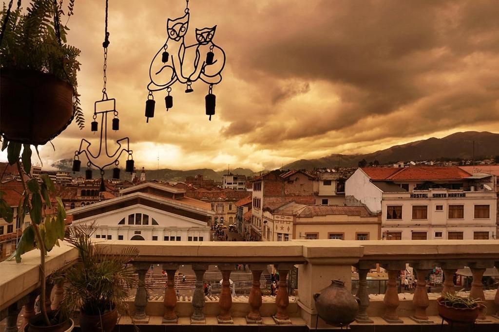 a view of a city from a balcony at El Cafecito Hostel Cuenca in Cuenca
