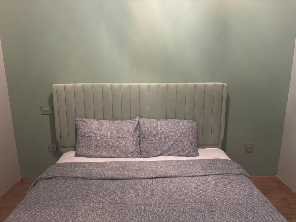 a bed with two pillows on top of it at Oliva 2 Bed Room in Casablanca