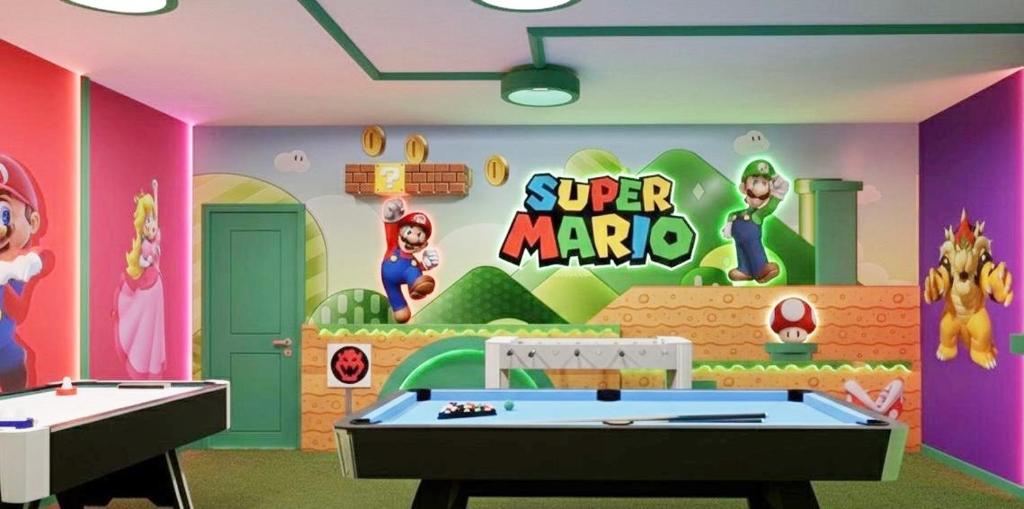 a room with a super mario room with a pool table at Modern 5BR Getaway w Heated Pool & Game Room in Orlando