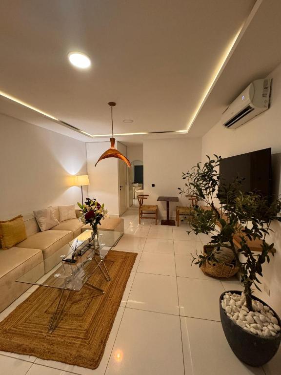 a living room with a couch and a table at ORY luxury garden in Abidjan