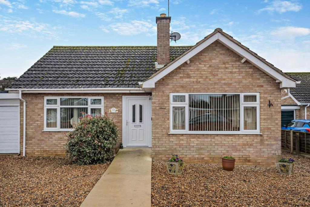 a brick house with a white door at 2 Bed in Snettisham oc-s28186 in Snettisham
