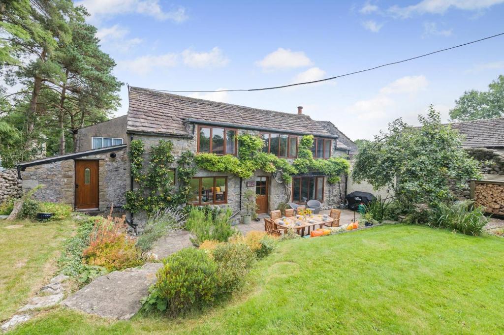 an exterior view of a house with a yard at 4 Bed in Malham oc-c32684 in Airton