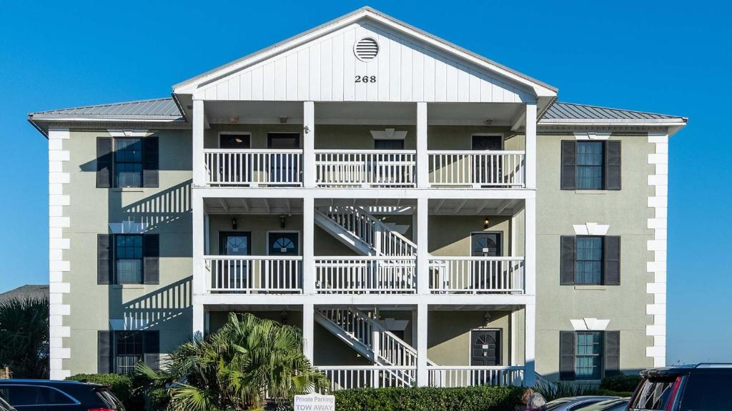 a large apartment building with balconies and a parking lot at Captains House A3 in Fernandina Beach