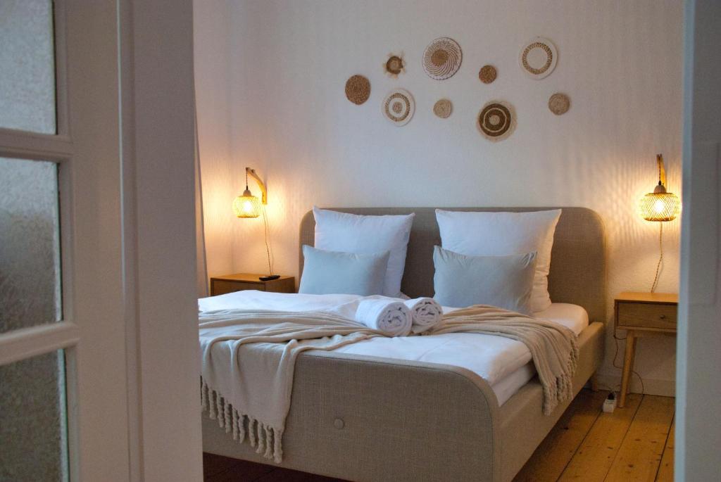 a bedroom with a bed with a baby on it at MS-Apartments I Quartier 4 in Leer