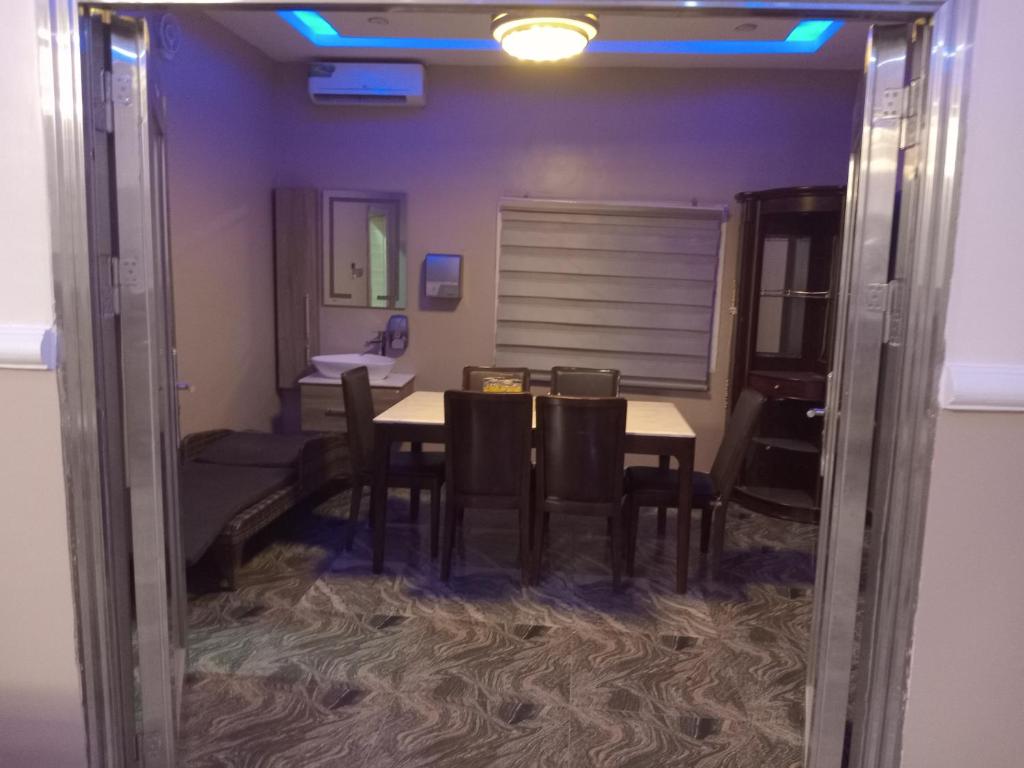 a dining room with a table and chairs at Miriya apartments in Abuja