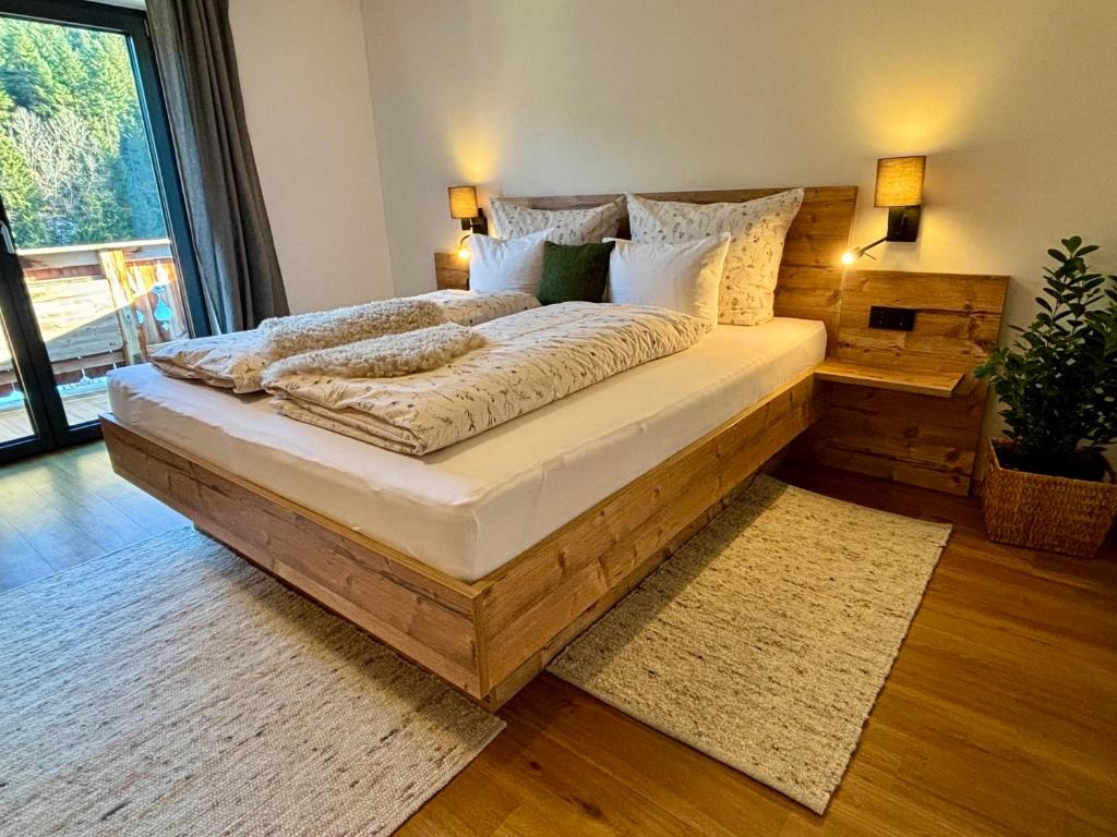 a large bed in a room with a large window at Landhaus Barbara in Kitzbühel