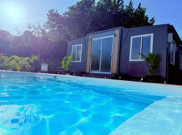 a house with a swimming pool in front of it at Casa Vagon Isla Bendita 2 in La Gonzalez