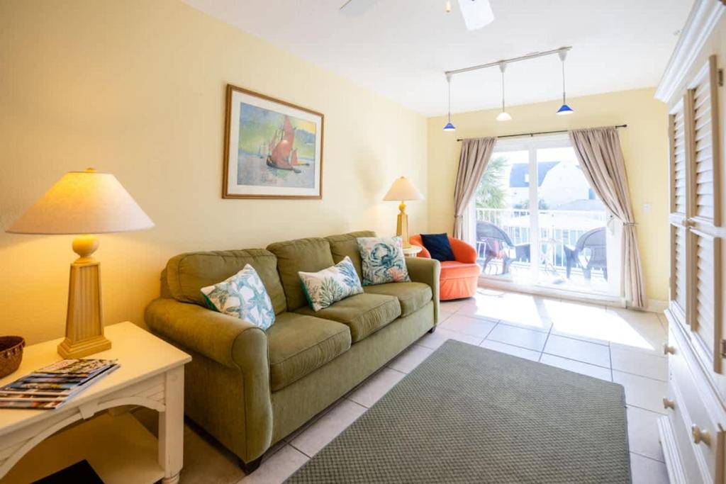 a living room with a couch and a table at The Terraces #202-Condo - Pool in Fernandina Beach