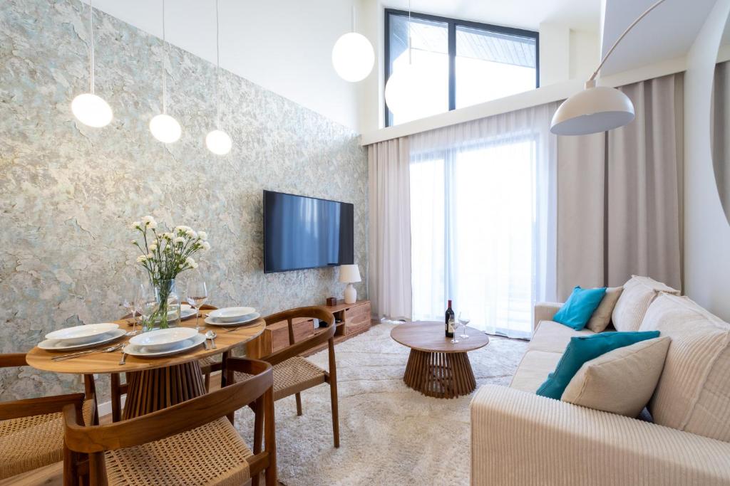 a living room with a couch and a table at Laguna Beskidów Resort - Desert Spring in Zarzecze