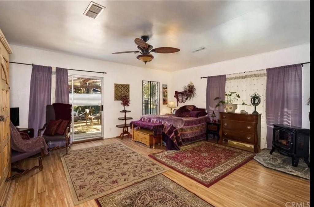 a bedroom with a bed and a ceiling fan at The Secret Hideaway in Oakhurst