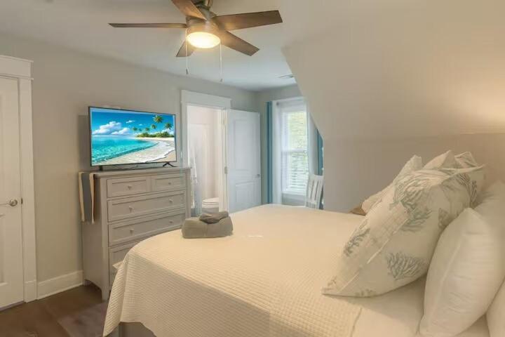 a bedroom with a bed with a flat screen tv at Ocean Pearl in Kill Devil Hills