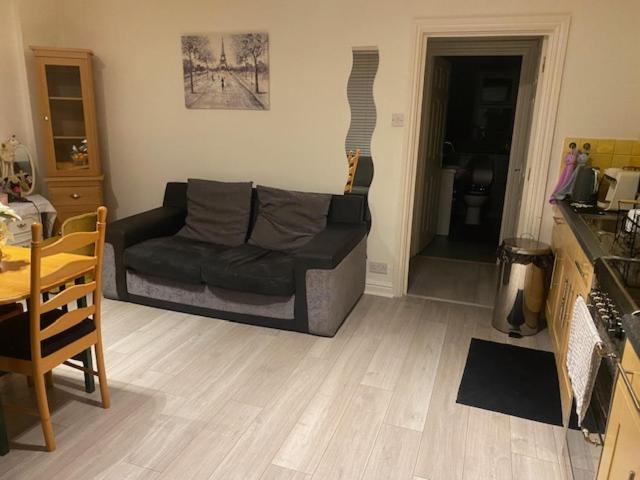 a living room with a couch and a table at 4 Castle Walk in Stansted Mountfitchet