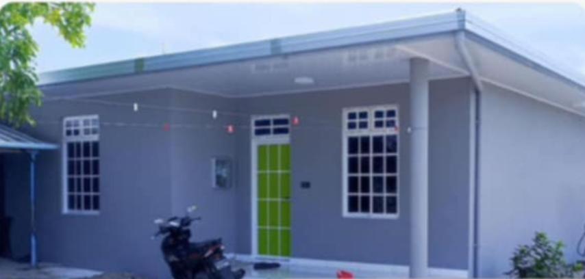 HanimaadhooBlue Rose Room Service的一栋房子前停着一辆摩托车