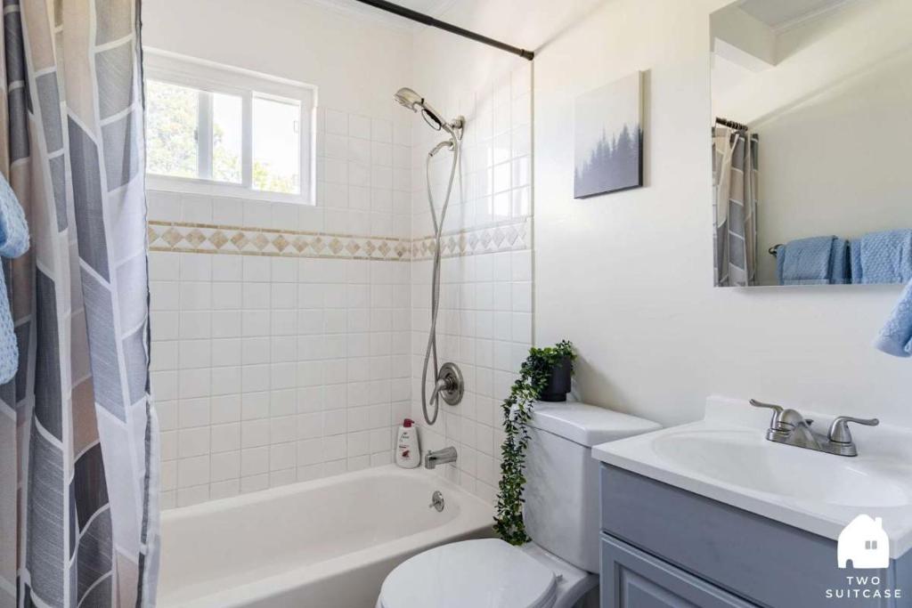 a bathroom with a tub and a toilet and a sink at Chic Abode In Central Berkley in Berkeley