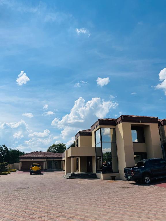a building with a car parked in a parking lot at Paradiso Palazzo in Welkom