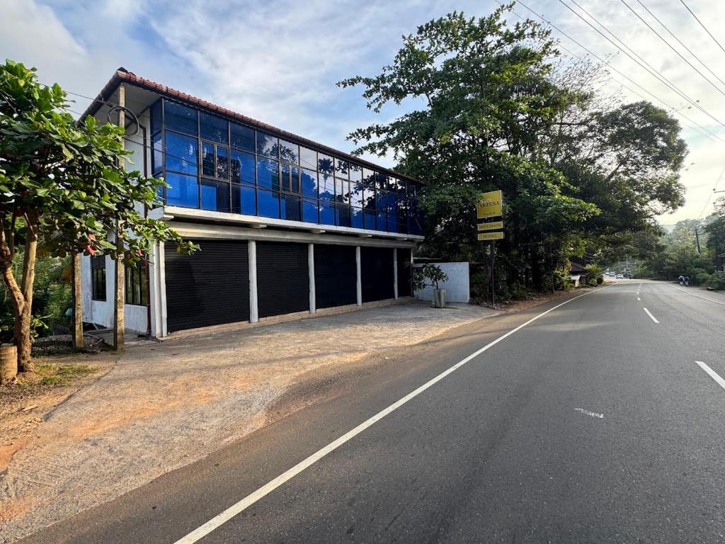a building with blue windows on the side of a road at Artesa 
