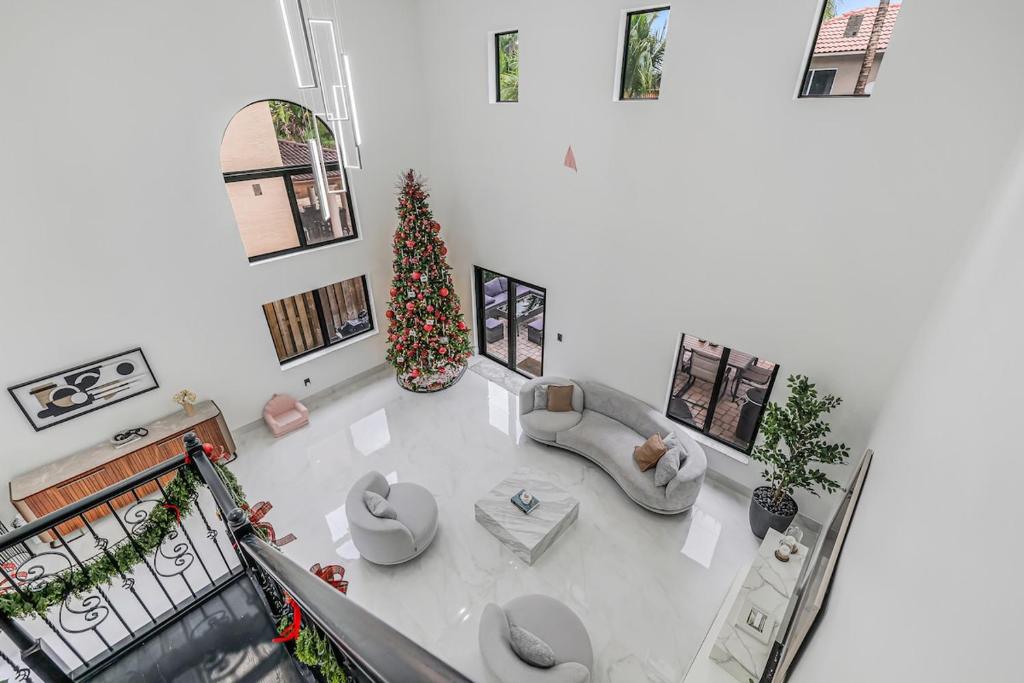 an overhead view of a living room with a christmas tree at Modern Miami Home with Patio and Pool in Country Walk