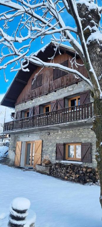 a house with a wooden roof in the snow at Chalet Le Chatelret - LE CHATELRET MAE-9361 in Vars