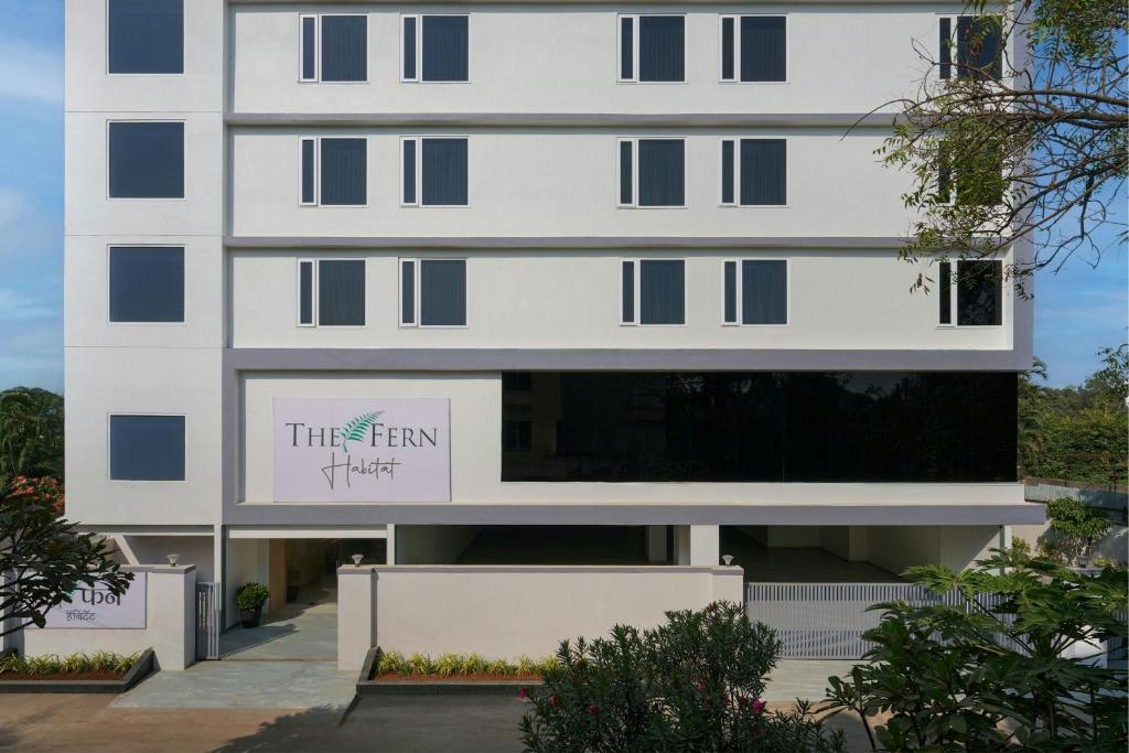 a white building with a sign on it at The Fern Habitat Pune, Mundhwa, Series by Marriott in Pune