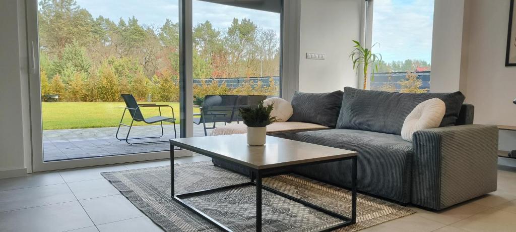a living room with a couch and a table at Wilga House 1 in Piła