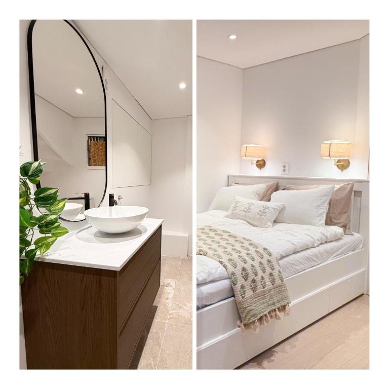 a bedroom with a bed and a sink and a mirror at Soft Stay Apartment in Bergen