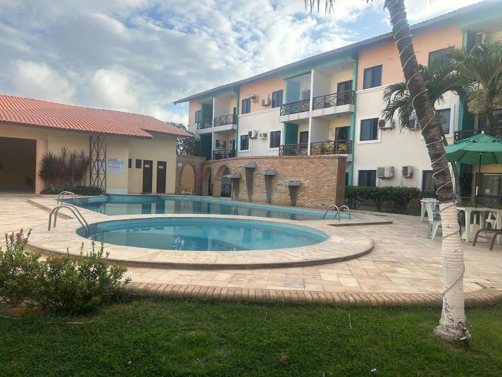 Swimmingpoolen hos eller tæt på Apartamento-flat no Porto das Dunas