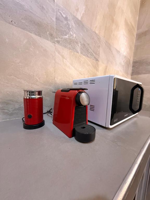 eine Küchenarbeitsplatte mit Mikrowelle und Toaster in der Unterkunft Keur Ébène - Appartement Cosy à Ouakam Batrain in Dakar