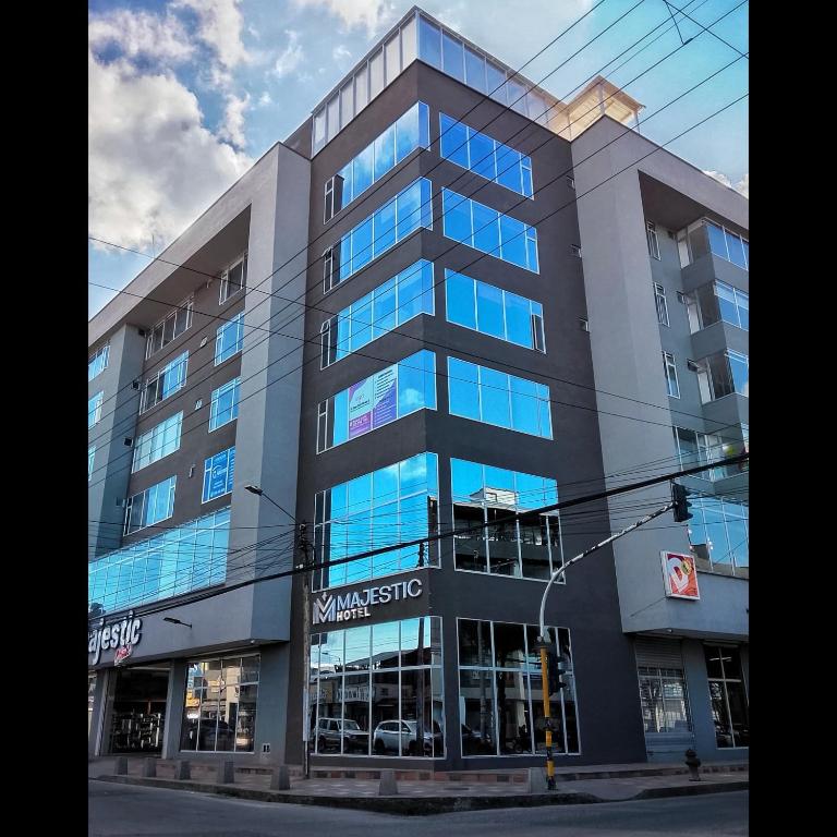 a building with glass windows on a city street at Majestic Hotel in Ipiales